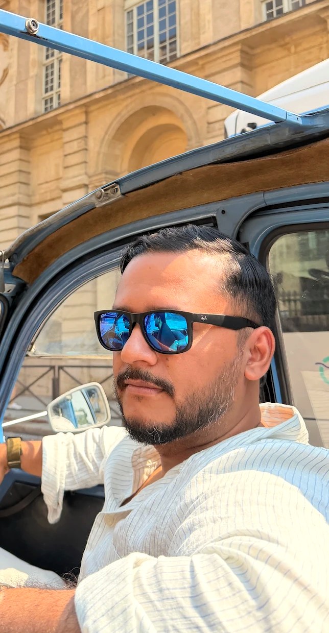 Byron in a vintage convertible, travelling in Europe